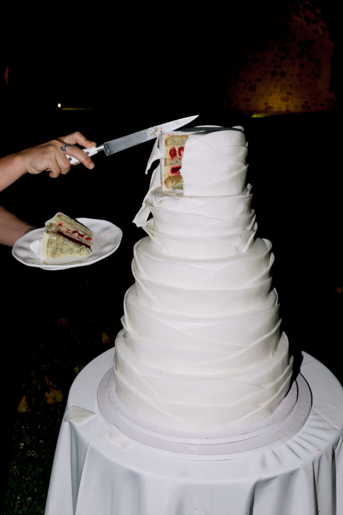 Close-up of a wedding cake being served at a luxury destination wedding reception in Provence, south of France